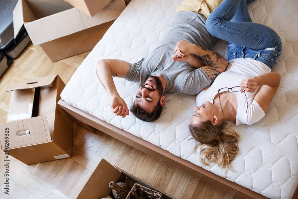 A couple laid on a bed