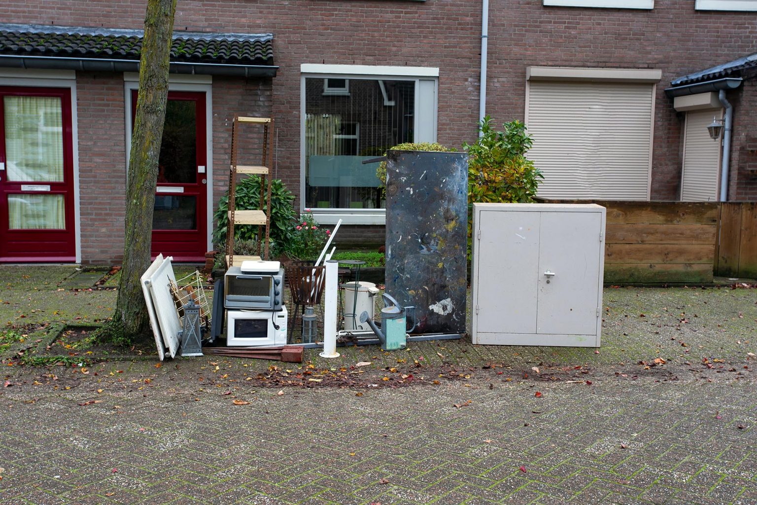 Old electronic waste and other iron things ready for pick up for recycling, bulky waste in a street