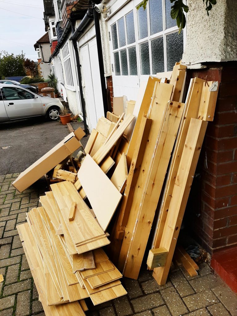 Junk pile of wood outside house rubbish for clearance